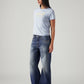 Women's Med Indigo Loose Bootcut Fit Mid Rise Jeans - Side View